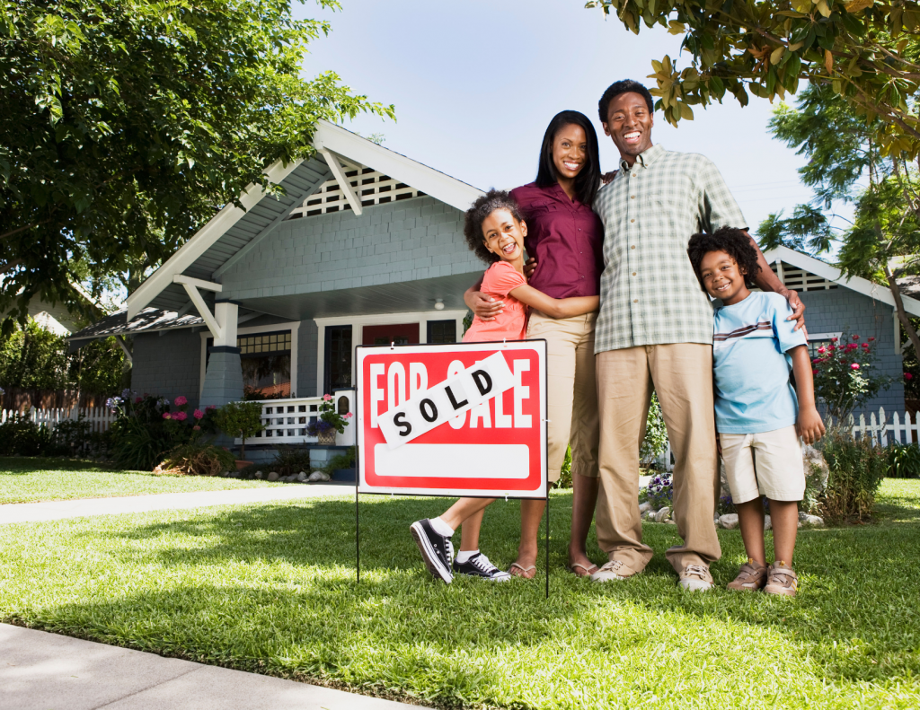 Family standing outside of a new home